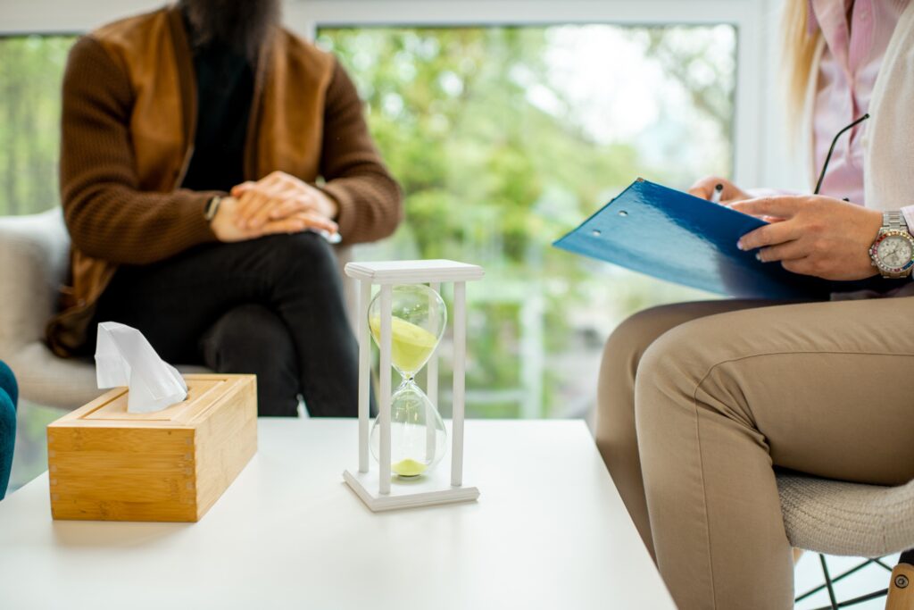 Man sitting with psychologist during the mental therapy